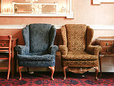 כורסא חומה וכחולה על שטיח אדום עם שידות ונברשות עת (צילום: istockphoto)