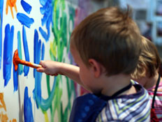 שני ילדים בפסים מציירים במכחול על קיר (צילום: tomhoryn, Istock)