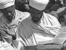 מוסלמי לבוש לבן מחזיק ספר גדול (צילום: Reuters)
