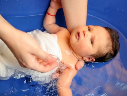 תינוקת באמבטיה מכוסה בבד (צילום: vladacanon, Istock)