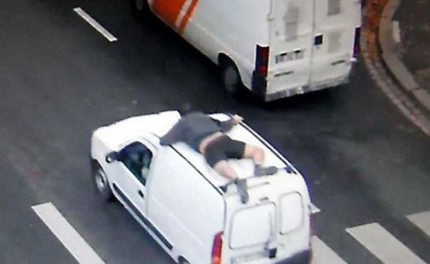 נתלה על הגג של רכב השודדים (צילום: dailymail.co.uk)