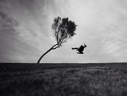 תורג'י מצלם את עצמו קופץ על עץ בשדה נטוש (צילום: איתי תורג'מן)