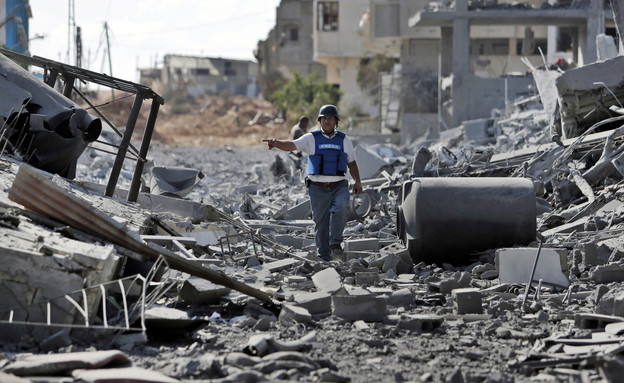 עיתונאי פלסטיני בין ההריסות בעזה (צילום: ap)