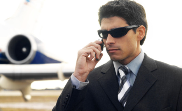 גבר בחליפת עסקים במטוס (צילום: אימג'בנק / Thinkstock)