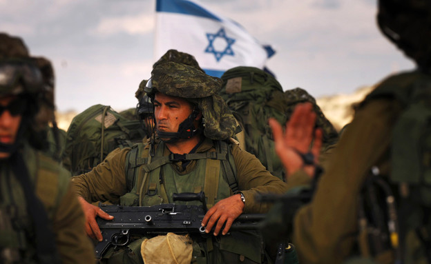 לוחם עם מא"ג ברקע דגל ישראל  (צילום: Handout, GettyImages IL)