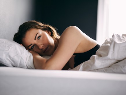אישה שוכבת במיטה (אילוסטרציה: Shutterstock)