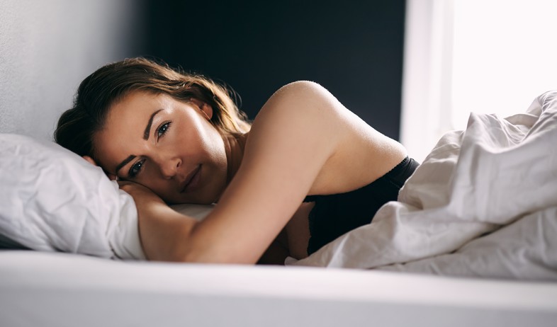 אישה שוכבת במיטה (אילוסטרציה: Shutterstock)
