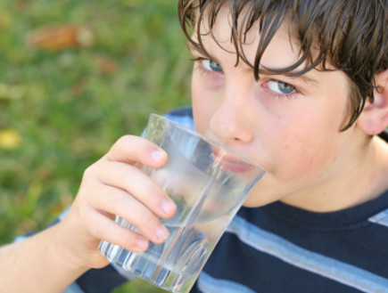 ילד שותה כוס מים