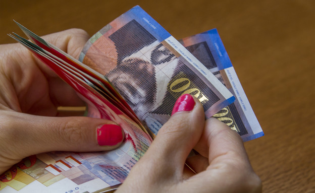 אישה סופרת כסף (צילום: Shutterstock)