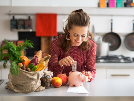  אישה שמחה שמה כסף בקופת חיסכון (צילום: Alliance, Shutterstock)