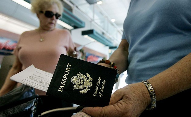 אישה מוציאה דרכון אמריקאי בשדה התעו (צילום: GettyImages - Sandy Huffaker)