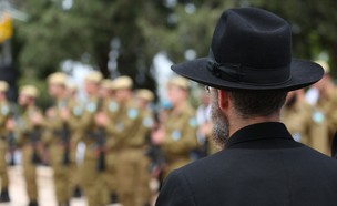 אדם חרדי עומד ליד חיילים (צילום: By Dafna A.meron, shutterstock)