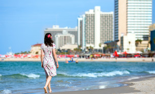 הולכת על החוף בתל אביב (צילום: vvvita, Shutterstock)