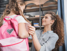 אמא מכינה את בתה לבית הספר