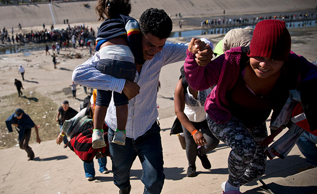 מהגרים שהצליחו לטפס על הגבול חרף האבטחה (צילום: AP, חדשות)