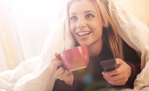 אישה צופה בטלוויזיה (צילום: shutterstock By Ollyy)