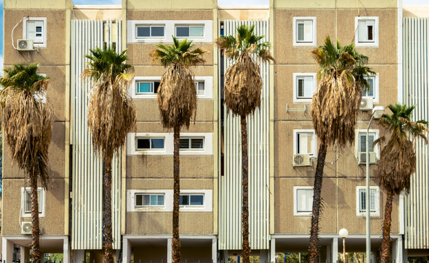 Facade of four storey house on columns with palm tree (צילום: By Dafna A.meron)