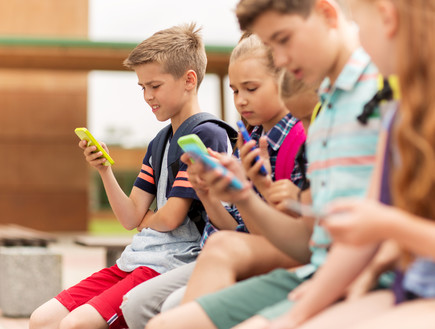 ילדים עם טלפון סלולרי (אילוסטרציה: By Dafna A.meron, shutterstock)