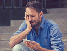 איש בוכה ומסתכל בטלפון 