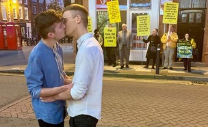הזוג הגאה שהתנשק מול מפגינים הומופובים (צילום:  Photo by Flash90, פייסבוק)