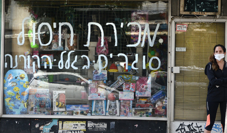 שלט סגירה על חלון הראווה של חנות קטנה בתל אביב (צילום: איל יצהר, גלובס)