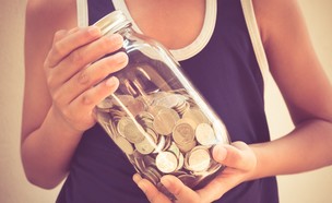 ילד מחזיק בצנצנת כסף (אילוסטרציה: Shutterstock)