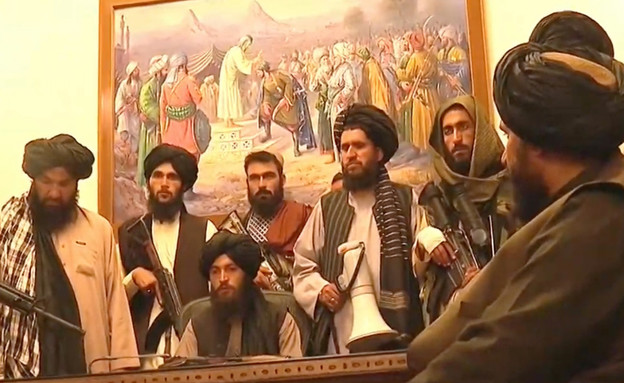 Taliban fighters with weapons in the presidential office in Afghanistan