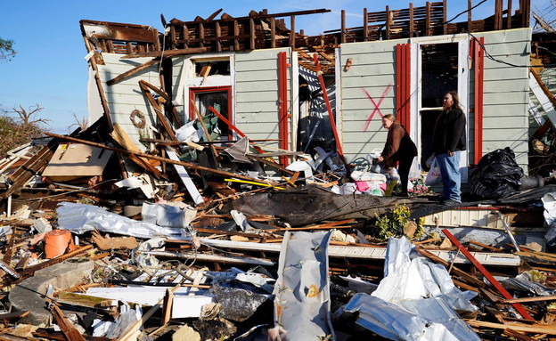 Mother and son stand outside their home after the tornado hit Mayfield Kentucky (Photo: Reuters) Mother and son stand outside their home after the tornado hit Mayfield Kentucky (Photo: Reuters)
