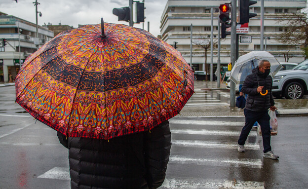 אנשים בגשם (צילום: אוליבייה פיטוסי, פלאש 90)