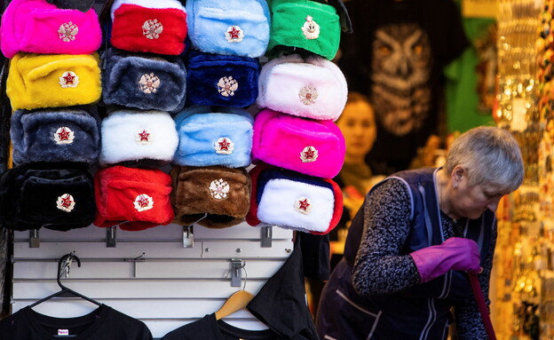 A woman cleans near a tourist hat shop, Moscow Russia (Photo: Reuters)