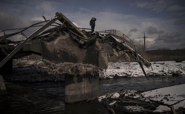 אדם עומד מעל גשר הרוס, אירפין, אוקראינה (צילום: AP)