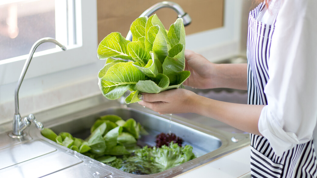 אישה שוטפת ירקות (צילום:  KamolpornAk, Shutterstock)
