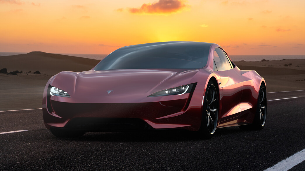 טסלה אדומה רוכבת בשקיעה טסלה אדומה רוכבת בשקיעה