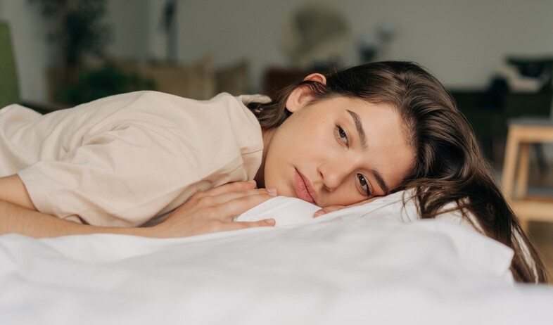 אישה מתוסכלת שוכבת על מיטה (אילוסטרציה: Ilona Kozhevnikova, shutterstock)