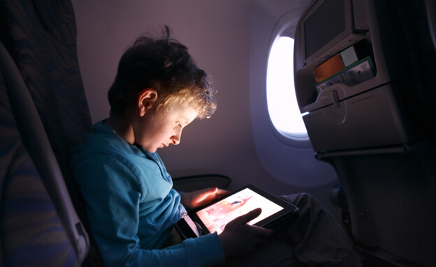 ילד עם מסך במטוס (צילום: narvikk, getty images)