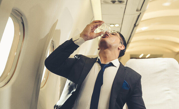 נוסע צמא שותה מטוס (צילום: Blue Planet Studio, shutterstock)