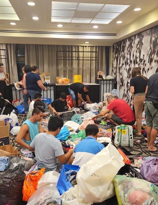אולם בהרודס תל אביב עם מתנדבים שמסדרים את הבגדים למפונים (צילום: באדיבות רשת פתאל)