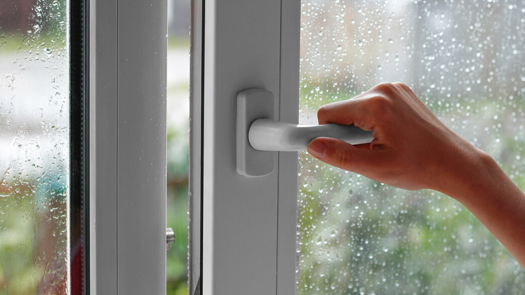 יד פותחת חלון ביום גשום
