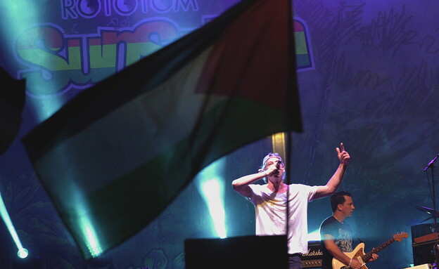 דגל פלסטיני מתנוסס בזמן שהמוזיקאי היהודי-אמריקני מתיסיהו (צילום: reuters)