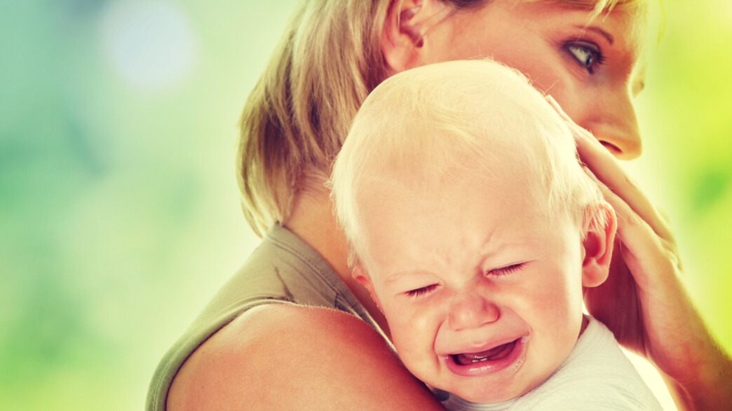 אמא מחבקת תינוק בוכה (צילום: Shutterstock)