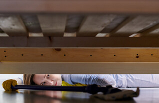 מנקה מתחת למיטה, עוזרת בית (צילום: travelarium.ph, Shutterstock)