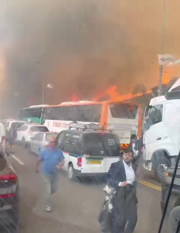 אנשים נוטשים את רכבם בכביש 1 בעקבות השרפה בהרי ירושלים